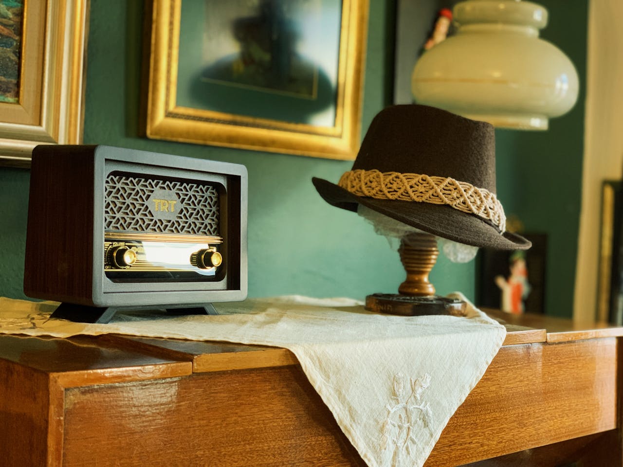 Retro-themed setup featuring vintage radio and fedora, evoking nostalgia.