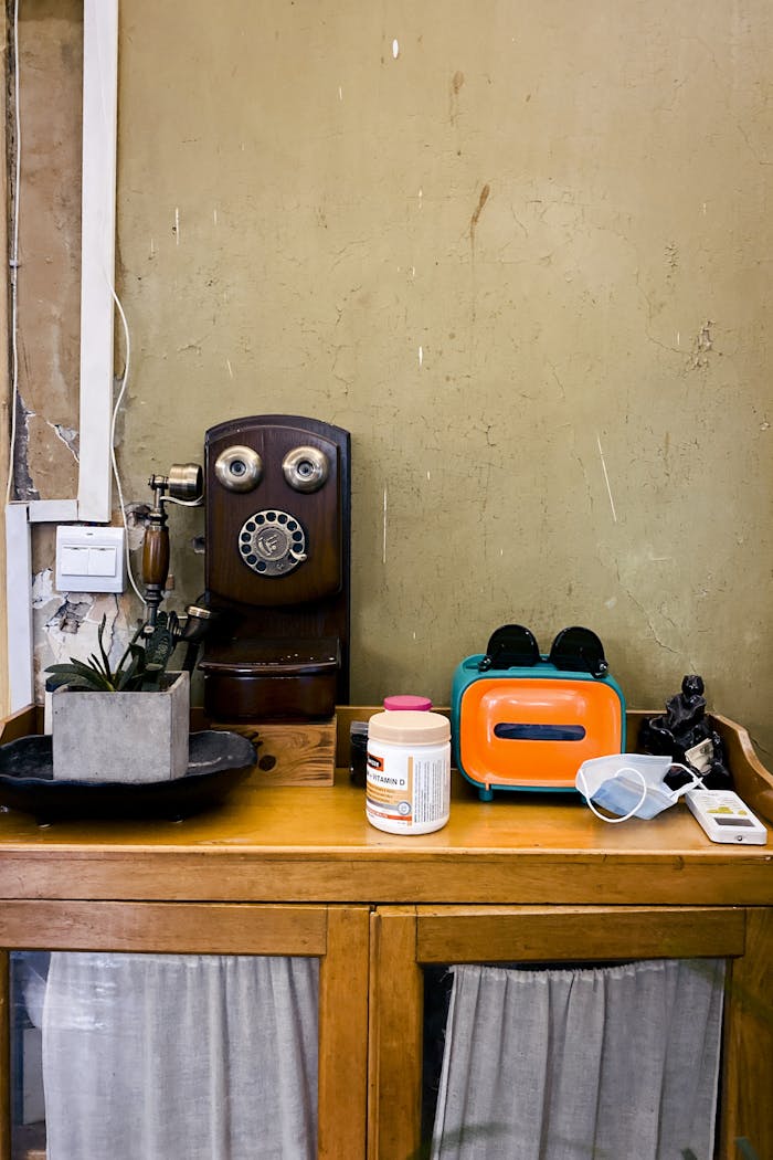 Retro room with vintage telephone, toaster on wooden cabinet, Wuhan, China.